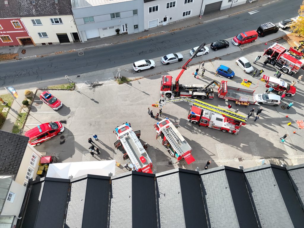 Luftaufnahme des Feuerwehrvorplatzes in Horn mit mehreren Feuerwehrfahrzeugen und ausgefahrener Drehleiter.